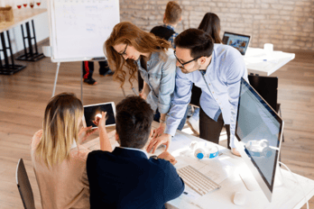 Employees discussing work tasks together