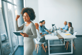 Employee celebrating the launch of a successful referral program for her small business.