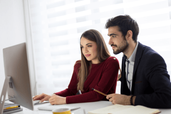 Employees having a discussion regarding improving gift card email open rates