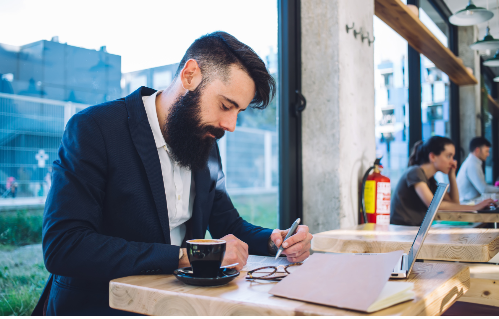 Man choosing gift from employee appreciation program in coffee shop.