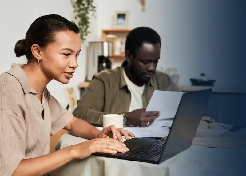 two research students working at a desk.