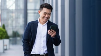 businessman receiving a gift card through his text messages on his phone