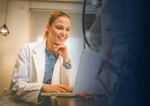 female researcher using laptop in lab