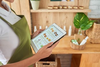 Natural cosmetics shop owner checking website of her online store